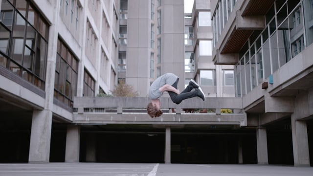A teen biy flipping in midair